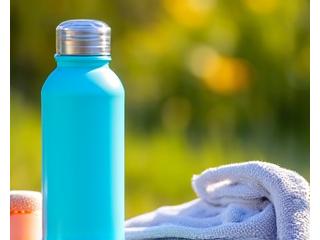 Bright summer outdoor scene with hydration bottles and light exercise gear.